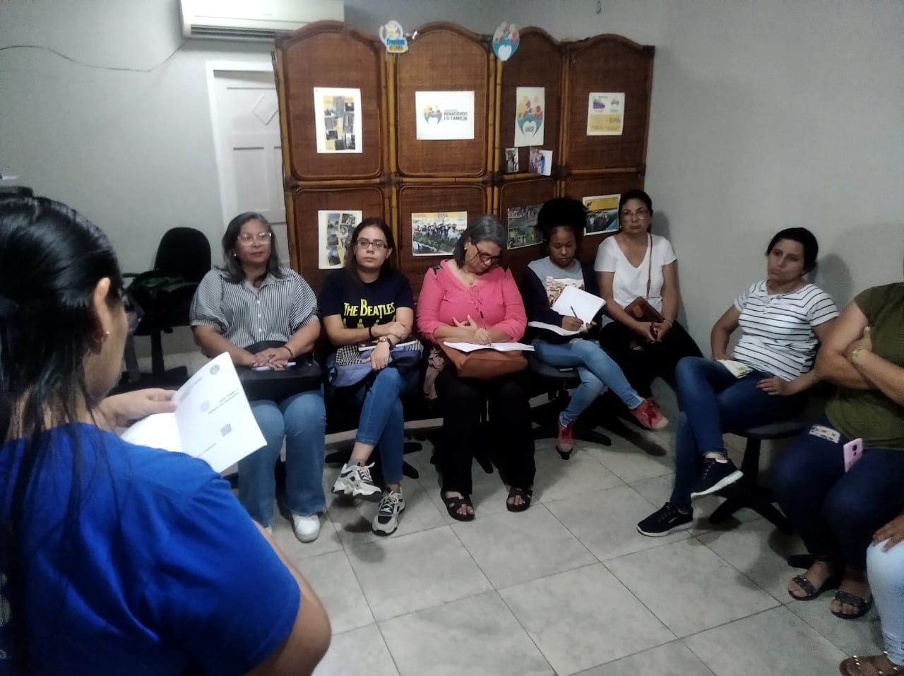 car interior from central back seat position showing driver and blurred view through windscreen of a busy road at night